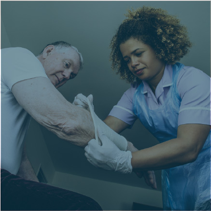 Woman applying bandage to elderly mans arm