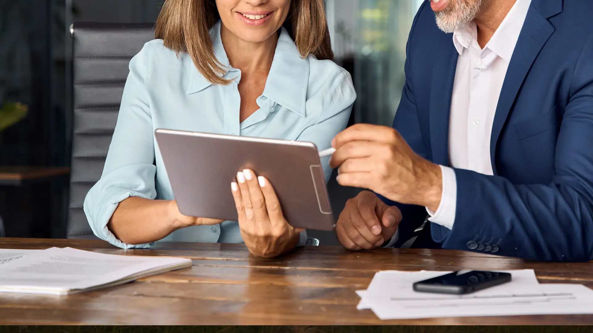 Two People Looking at a Tablet